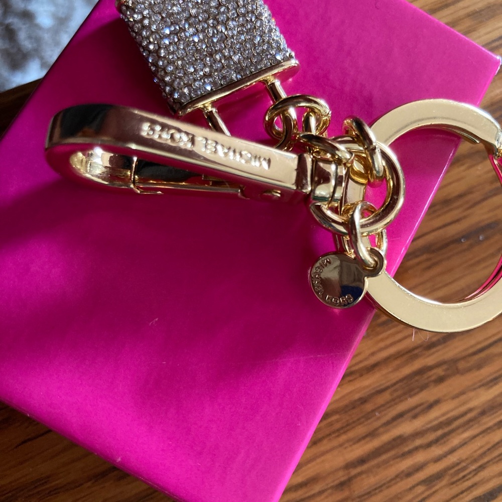 Michael Korrs pouch with Michael Kors purse charm